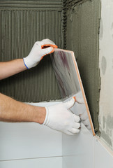 Installing the tiles on the wall.