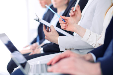 Close-up of hands holding pens and asking question at the conference