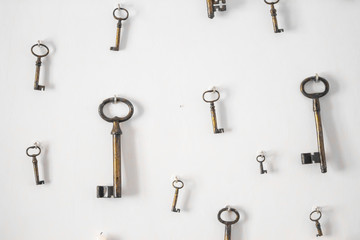 Blurred image vintage style. Key hang on the white wall background / ancient key wallpaper.