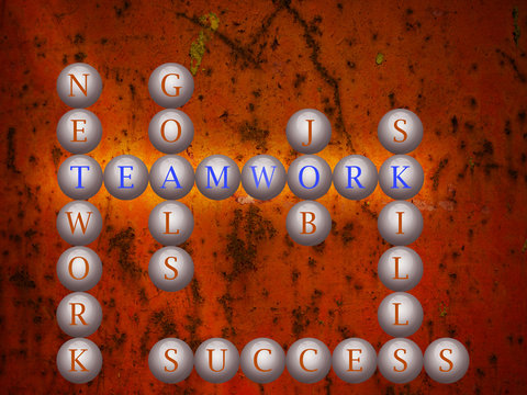 Teamwork word cloud writen on balls infront of a wall background