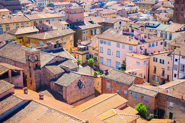 Beautiful view from the roof of ancient old buildings with red roofs in Lucca, Italy - obrazy, fototapety, plakaty
