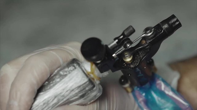 Close up of working tattoo machine slow motion HD