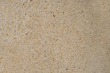 fragment of stone surface,natural camstone or artificial stone cover toned in sand color