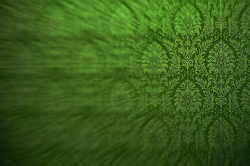 Fragment of ornamental wallpaper colored bright green blurred by purpose