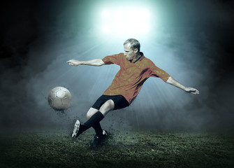 Soccer player with ball in action outdoors