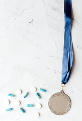 Concept of doping in sport - deprivation medals top view