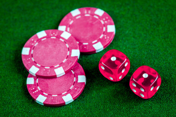 poker chips and dice on green background top view