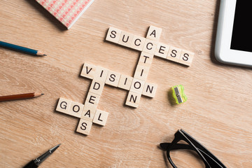 Conceptual business keywords on table with elements of game making crossword