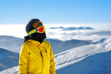 Fototapeta na wymiar girl in a mask for snowboarding and helmet against the backdrop