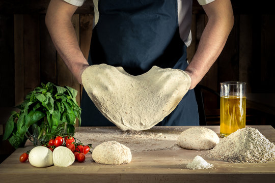 Italian pizza making dough stretching olive oil mozzarella cheese wood fire oven