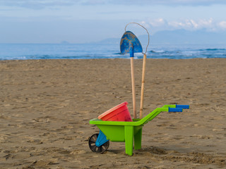 toys on the beach plastic wheelbarrow, bucket and spade