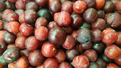Photo with bunch of red plums