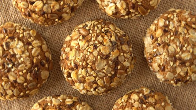 Delicious yummy freshly baked homemade oatmeal cookies rotating on a sackcloth. Looped.