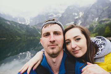 Happpy couple taking selfie withe lake background