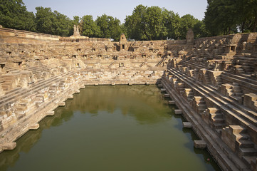 Ancient stepped water tank in front of the Sun Temple at Modhera. Ancient Hindu temple built circa 1027. Gujarat, India.