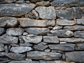 Pattern of decorative brown grey slate stone wall