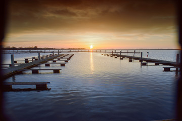 Fototapeta premium Yacht port over orange sunset