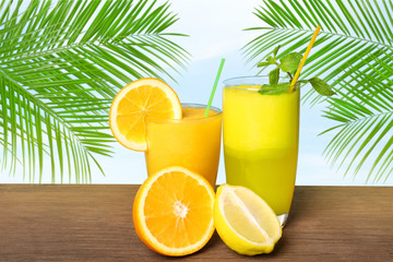 Glasses of delicious cocktails on wooden table