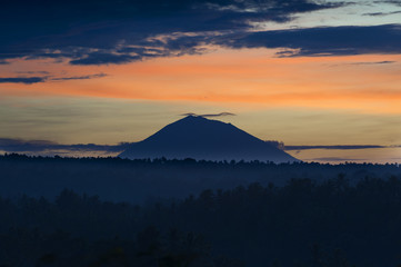 Mt. Batukaru. Gunung Batukaru, sometimes spelled Batukau, is Bali's second-highest mountain at 2,276 m. It is the highest peak in the Bedugul volcanic area, but is dormant. Photographed at sunrise.