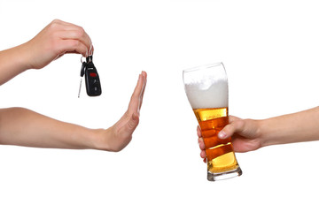 Woman with car key refusing glass of beer, on white background. Don't drink and drive concept