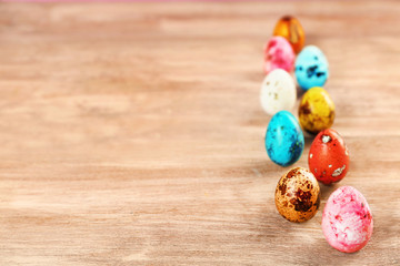 Colorful Easter eggs on wooden table