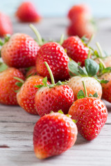 Strawberries with leaves on a wooden background