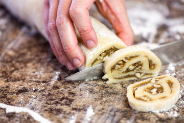 Cutting spiral cookies from a log of cookie dough