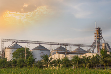 manufacture factory, industry plant and sunlight of sunset at evening