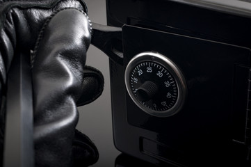Home invasion and burglary concept with first person view of a burglar wearing black leather gloves...