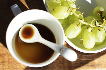 Empty withe cup of coffee, breakfast with grapes.