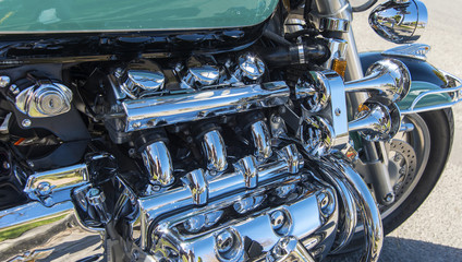 Fototapeta na wymiar Close up side Motor cycle chrome detail reflections.