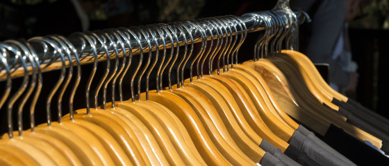 Clothes hangers Rack street market close up.