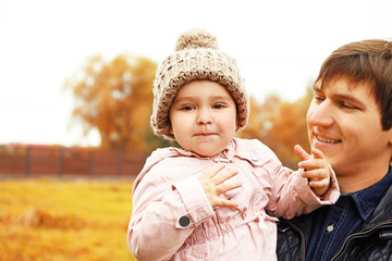 Father with cute child outdoors, close up view