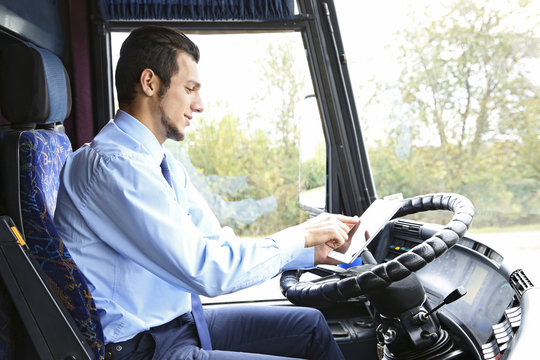 Handsome Driver With Tablet Sitting In Bus