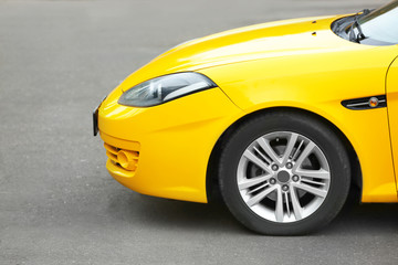 Modern yellow car on road