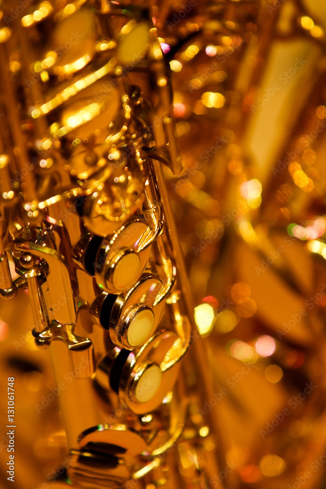 Wall mural fragment valves saxophone closeup in golden tones