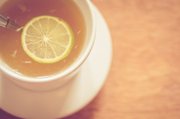 Blur copy space of lemon tea on wood table background.