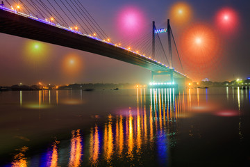 Vidyasagar bridge (setu) in night illumination at dusk with fireworks