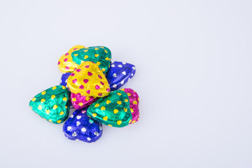 Chocolate or Colorful heart shape chocolate on a background.