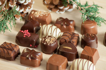 lot of variety chocolate pralines on wood background