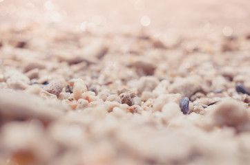 Tropical sunset beach with bokeh sun light sand abstract background.