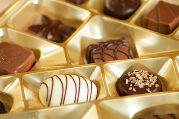 lot of variety chocolate pralines on wood background