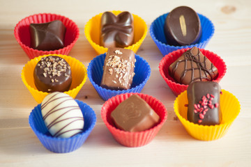 lot of variety chocolate pralines on wood background