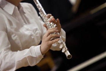 Hands of the girl playing a flute closeup © furtseff