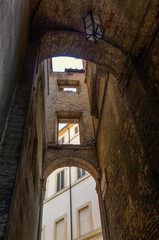 arches between historical buildings in Siena