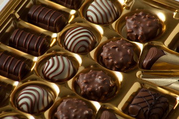 lot of variety chocolate pralines on wood background