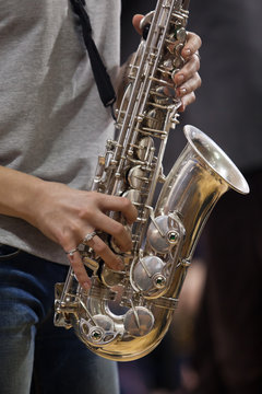 Hands girl playing the saxophone 
