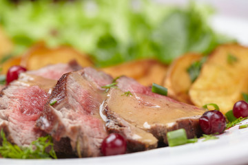 Tasty roasted pork meat with potatoes