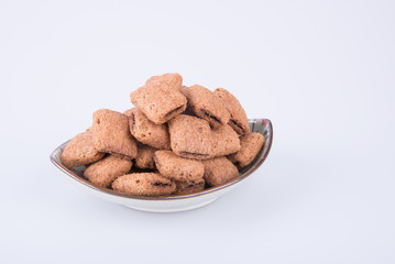 cookie or biscuits filled with chocolate cream on a background.