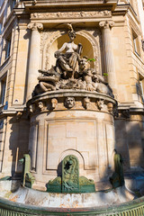Fototapeta na wymiar historic fountain at a building in Paris, France